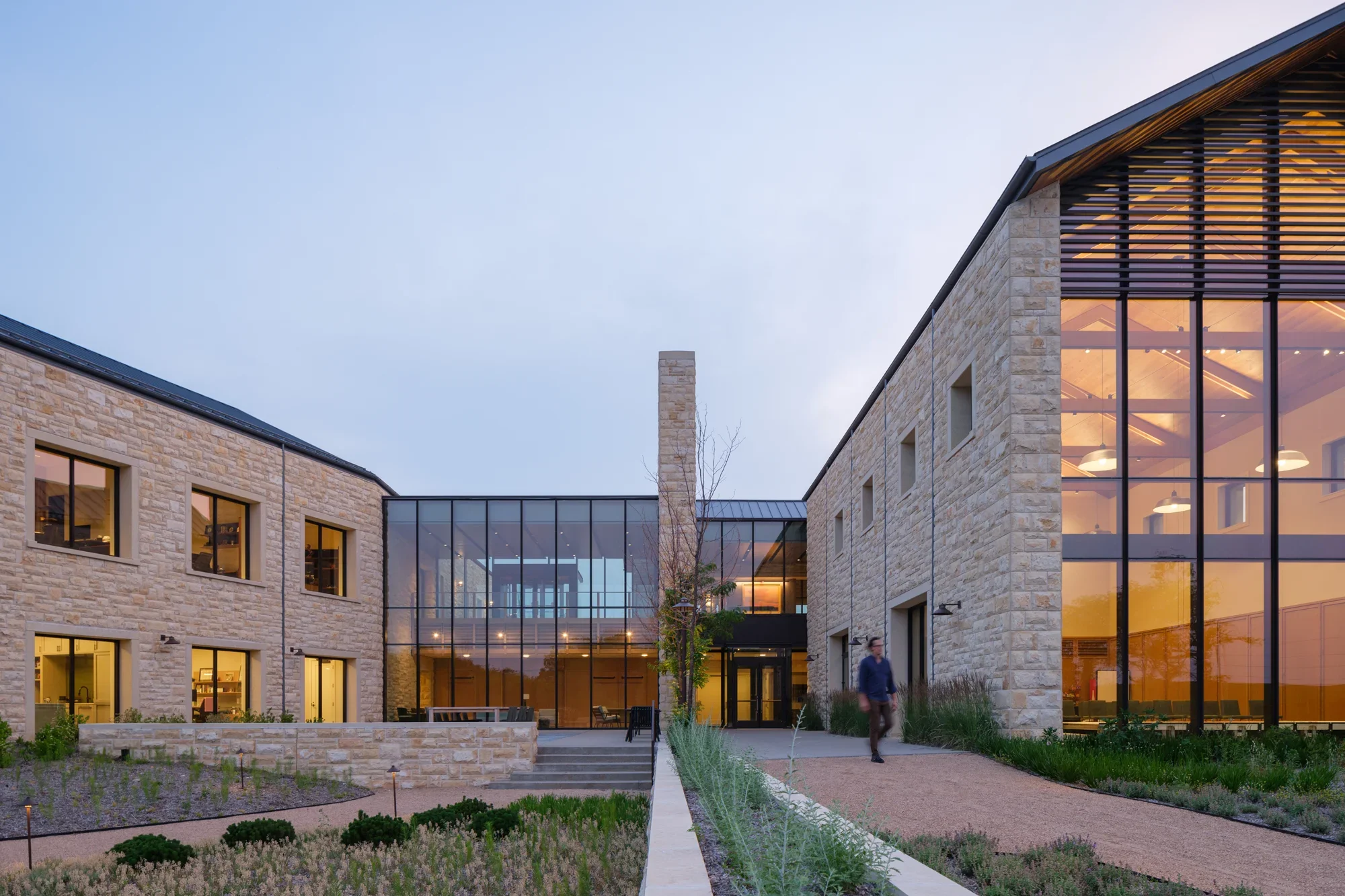 Focal Herzog Foundation exterior view limestone walls large modern window glass connector gravel paths 