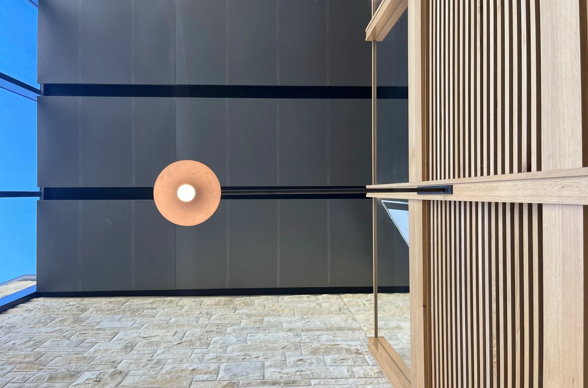Focal Herzog Foundation interior metal ceiling panels lighting limestone wall wood and glass guardrail