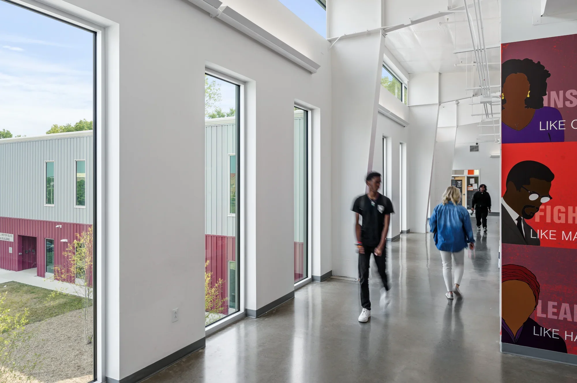 Focal Hogan Preparatory Academy white interior concrete flooring large windows colorful murals